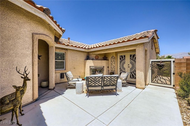 4361 Valley Quail Way N, Las Vegas, NV 89084 - view of patio / terrace with an outdoor living space with a fireplace and a gate