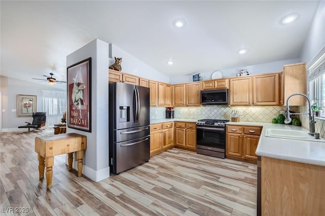 4361 Valley Quail Way N, Las Vegas, NV 89084 - kitchen with appliances with stainless steel finishes, light countertops, light wood-style flooring, tasteful backsplash, and vaulted ceiling