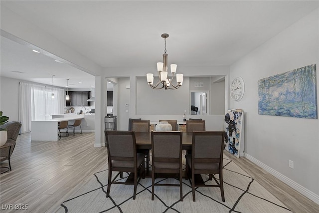 7890 S Miller Ln, Las Vegas, NV 89113 - dining space with a chandelier, light wood-style flooring, and recessed lighting
