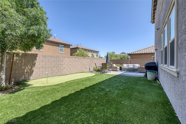 7890 S Miller Ln, Las Vegas, NV 89113 - fenced backyard featuring a putting area, outdoor lounge area, and a patio area