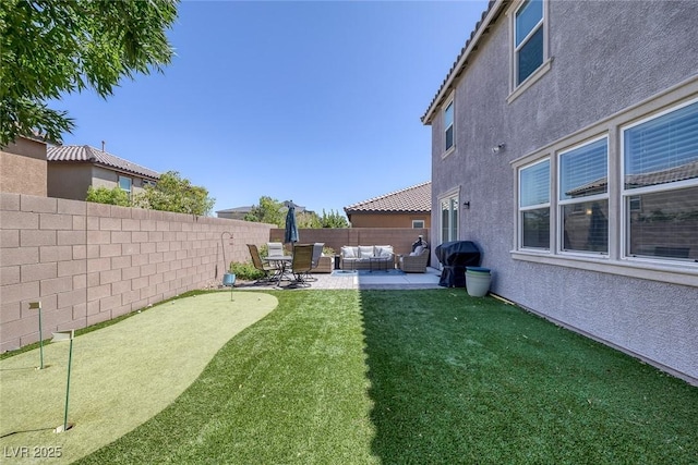 7890 S Miller Ln, Las Vegas, NV 89113 - fenced backyard featuring an area to practice putting, an outdoor hangout area, and a patio