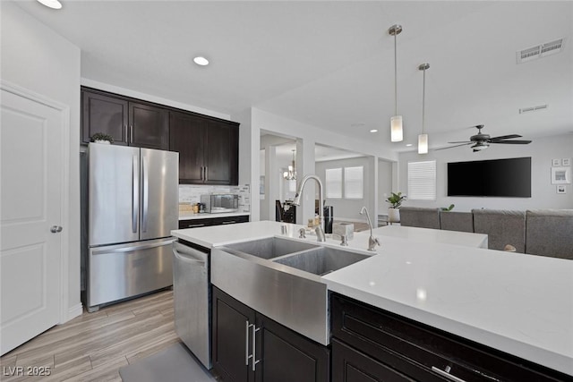 7890 S Miller Ln, Las Vegas, NV 89113 - kitchen with appliances with stainless steel finishes, light countertops, decorative light fixtures, ceiling fan, and backsplash