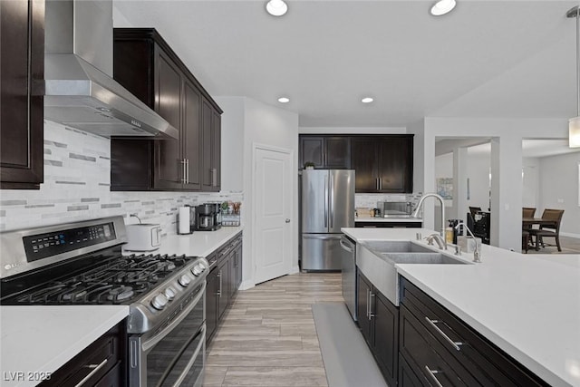 7890 S Miller Ln, Las Vegas, NV 89113 - kitchen with appliances with stainless steel finishes, wall chimney range hood, backsplash, recessed lighting, and light countertops