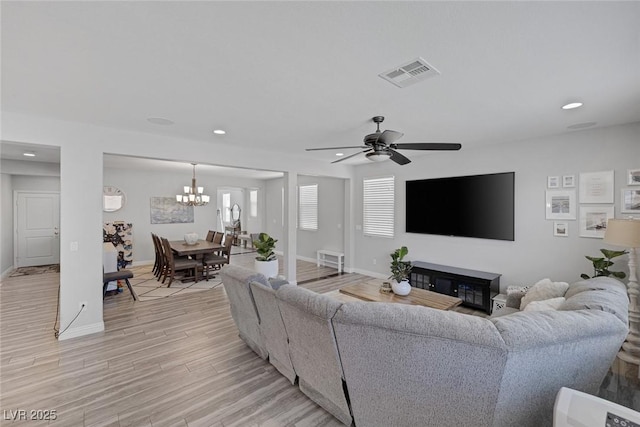 7890 S Miller Ln, Las Vegas, NV 89113 - living area featuring light wood-type flooring, recessed lighting, a ceiling fan, and a chandelier
