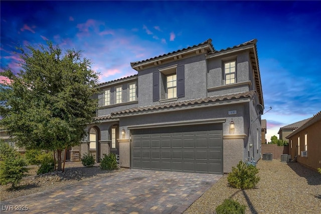 7890 S Miller Ln, Las Vegas, NV 89113 - mediterranean / spanish-style house featuring a tiled roof, an attached garage, stucco siding, and decorative driveway