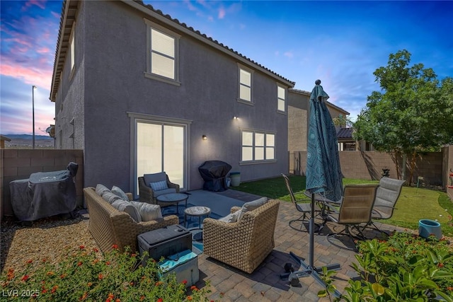 7890 S Miller Ln, Las Vegas, NV 89113 - back of house at dusk featuring stucco siding, a fenced backyard, and a patio area