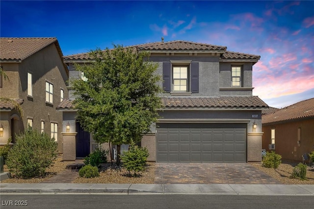 7890 S Miller Ln, Las Vegas, NV 89113 - view of front facade featuring a tiled roof, an attached garage, driveway, and stucco siding
