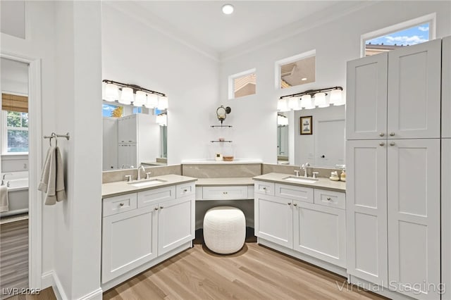 10920 Grand Haven Ave, Las Vegas, NV 89134 - full bath with two vanities, wood finished floors, ornamental molding, and recessed lighting