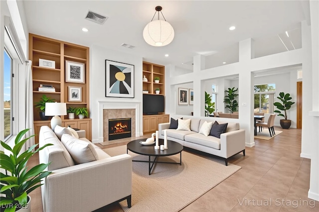 10920 Grand Haven Ave, Las Vegas, NV 89134 - living room featuring built in features, a fireplace, light tile patterned floors, and recessed lighting