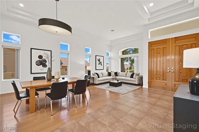 10920 Grand Haven Ave, Las Vegas, NV 89134 - dining room with a tray ceiling, a towering ceiling, recessed lighting, and light wood-style floors