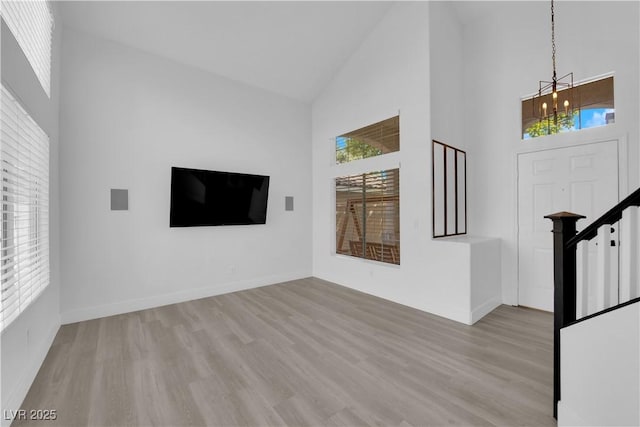 21 Rue De Degas, Henderson, NV 89074 - unfurnished living room featuring high vaulted ceiling, a chandelier, and wood finished floors