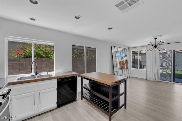 21 Rue De Degas, Henderson, NV 89074 - kitchen featuring black dishwasher, gas stove, light wood-type flooring, white cabinetry, and a chandelier