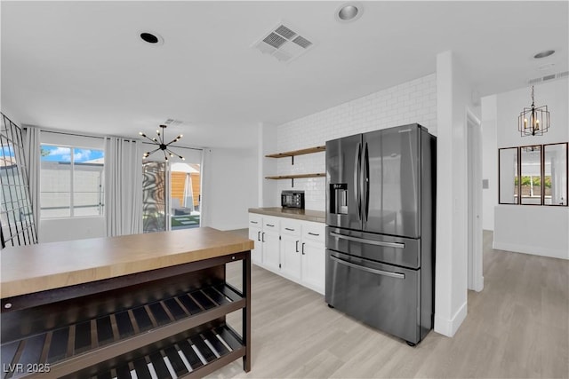 21 Rue De Degas, Henderson, NV 89074 - kitchen featuring stainless steel fridge with ice dispenser, a chandelier, light wood-style floors, white cabinets, and recessed lighting