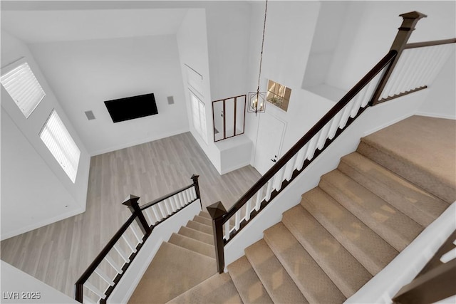 21 Rue De Degas, Henderson, NV 89074 - stairway featuring wood finished floors, high vaulted ceiling, and a chandelier