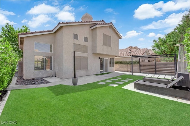 21 Rue De Degas, Henderson, NV 89074 - rear view of house with a fenced backyard, a chimney, stucco siding, a tiled roof, and a patio