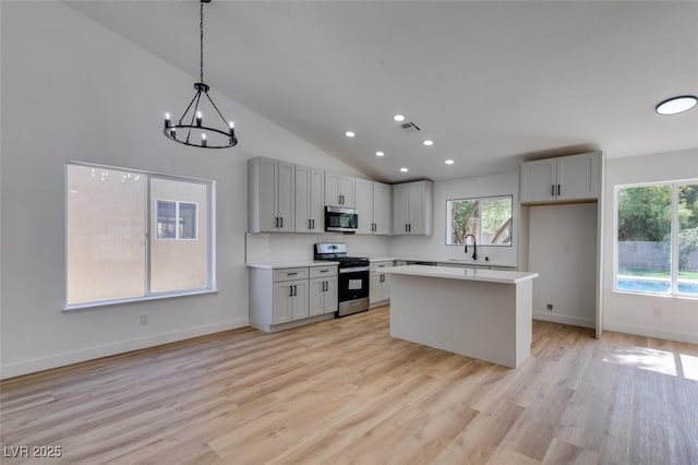 6126 Bedrock Ct, North Las Vegas, NV 89031 - kitchen with appliances with stainless steel finishes, healthy amount of natural light, light countertops, light wood-style flooring, and recessed lighting