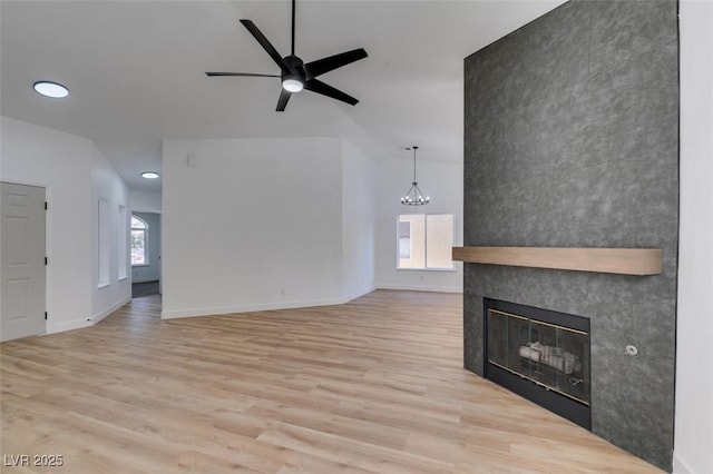 6126 Bedrock Ct, North Las Vegas, NV 89031 - unfurnished living room with wood finished floors, a ceiling fan, a tile fireplace, and recessed lighting