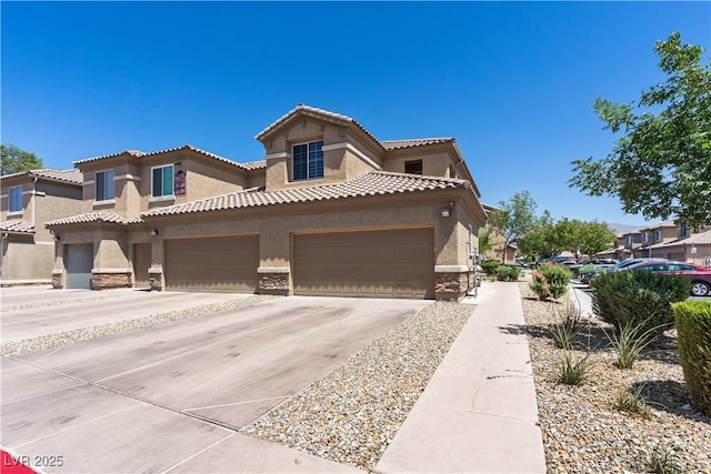 6635 Caporetto Ln Unit 204, North Las Vegas, NV 89084 - mediterranean / spanish house featuring stucco siding, stone siding, driveway, a tile roof, and a garage