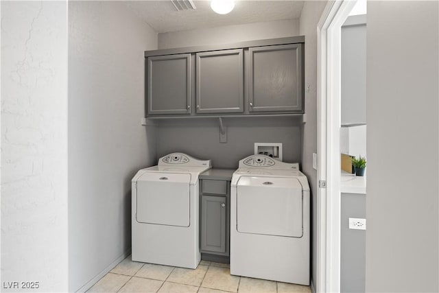 6635 Caporetto Ln Unit 204, North Las Vegas, NV 89084 - washroom with cabinet space, independent washer and dryer, and light tile patterned flooring