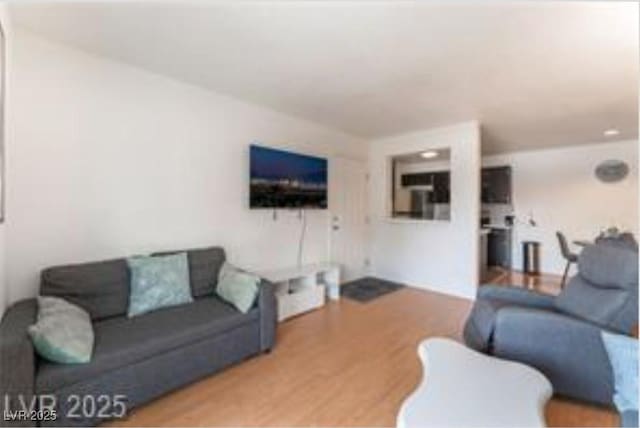 221 Mission Catalina Ln Unit 104, Las Vegas, NV 89107 - living room featuring wood finished floors