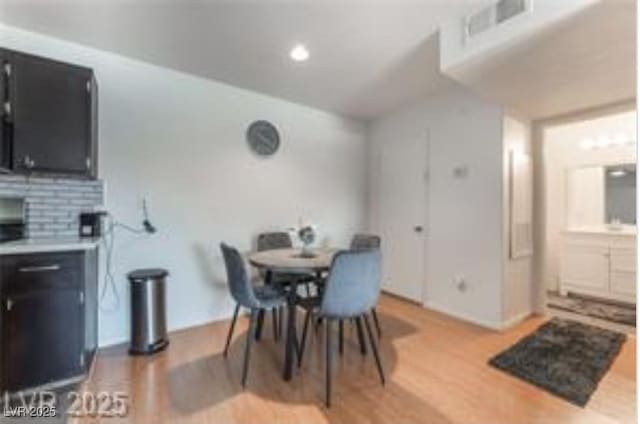 221 Mission Catalina Ln Unit 104, Las Vegas, NV 89107 - dining space with light wood-style floors