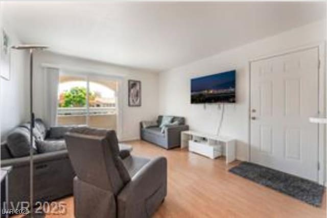 221 Mission Catalina Ln Unit 104, Las Vegas, NV 89107 - living room featuring wood finished floors