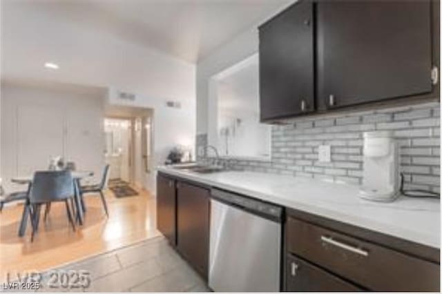 221 Mission Catalina Ln Unit 104, Las Vegas, NV 89107 - kitchen with dishwasher, light countertops, and backsplash