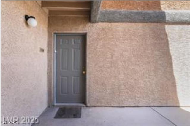 221 Mission Catalina Ln Unit 104, Las Vegas, NV 89107 - view of exterior entry featuring stucco siding