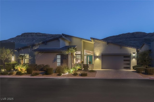 10271 Meridian Hill Ave, Las Vegas, NV 89135 - view of front of home with driveway, stucco siding, a garage, and a mountain view
