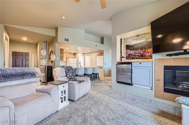 2325 Windmill Pkwy Unit 1622, Henderson, NV 89074 - carpeted living room featuring a ceiling fan and a fireplace