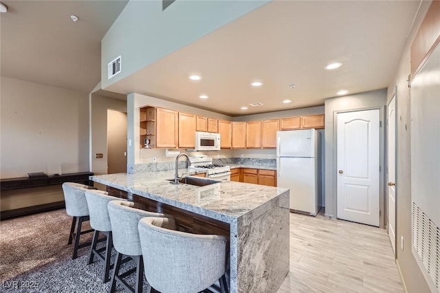 2325 Windmill Pkwy Unit 1622, Henderson, NV 89074 - kitchen featuring white appliances, light brown cabinetry, a peninsula, open shelves, and light stone countertops
