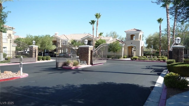 2325 Windmill Pkwy Unit 1622, Henderson, NV 89074 - view of asphalt street with a gate, curbs, a gated entry, and street lighting