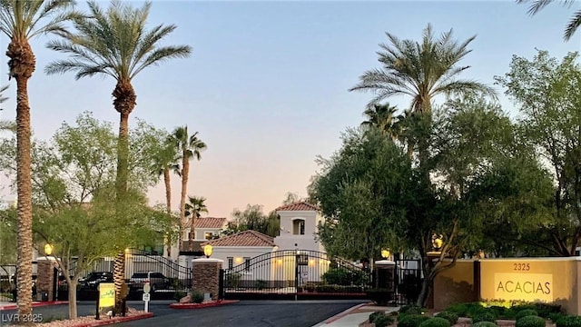 2325 Windmill Pkwy Unit 1622, Henderson, NV 89074 - view of asphalt road with a gate, curbs, and a gated entry
