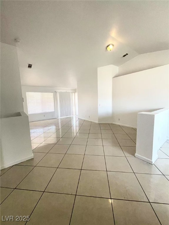 2405 Prime Advantage Ave, North Las Vegas, NV 89032 - spare room featuring light tile patterned floors and vaulted ceiling