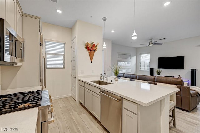 912 Allister Fields Ln, Las Vegas, NV 89138 - kitchen with appliances with stainless steel finishes, open floor plan, light wood finished floors, light countertops, and recessed lighting