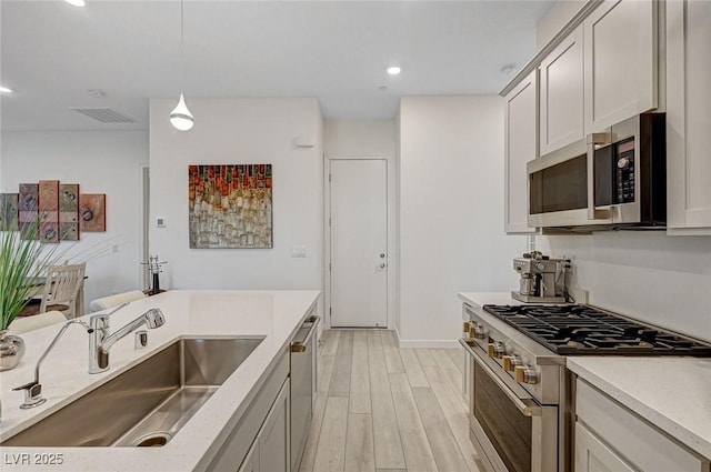 912 Allister Fields Ln, Las Vegas, NV 89138 - kitchen with appliances with stainless steel finishes, light wood-style flooring, recessed lighting, and hanging light fixtures