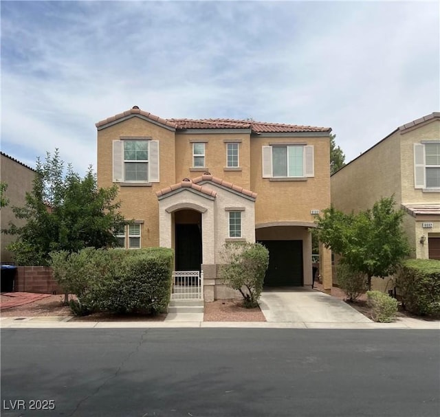 9100 Hombard Ave, Las Vegas, NV 89148 - view of front facade featuring a tiled roof, stucco siding, a garage, and driveway