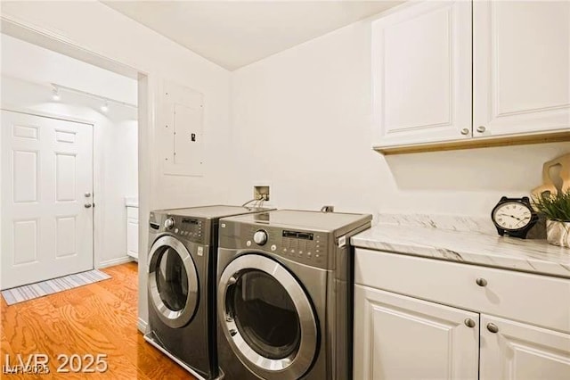 1470 St Joseph St, Overton, NV 89040 - washroom with cabinet space, light wood-type flooring, washing machine and clothes dryer, and electric panel
