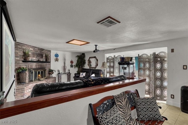 5005 Harmony Ave, Las Vegas, NV 89107 - kitchen featuring tile patterned floors, a brick fireplace, and a textured ceiling