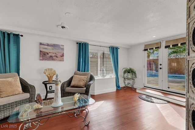 5005 Harmony Ave, Las Vegas, NV 89107 - living area featuring a textured ceiling, wood finished floors, and french doors