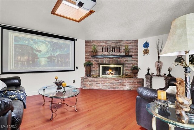5005 Harmony Ave, Las Vegas, NV 89107 - living area with wood finished floors, a fireplace, a skylight, and a textured ceiling