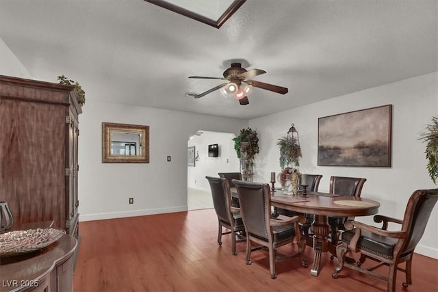 5005 Harmony Ave, Las Vegas, NV 89107 - dining area featuring a ceiling fan, arched walkways, and wood finished floors