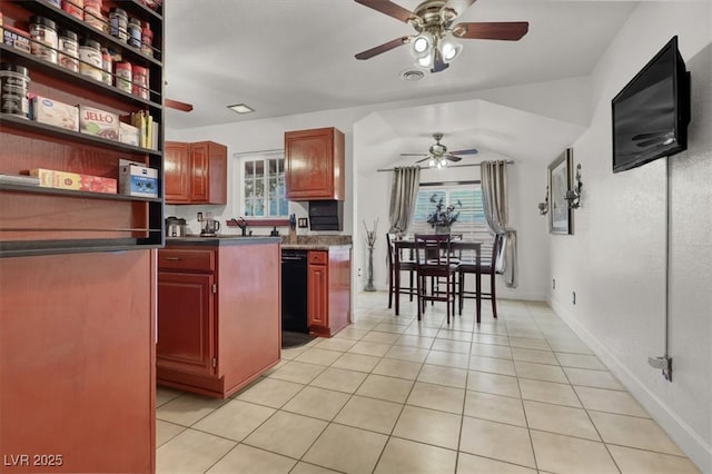 5005 Harmony Ave, Las Vegas, NV 89107 - kitchen featuring ceiling fan, black dishwasher, dark countertops, light tile patterned flooring, and reddish brown cabinets