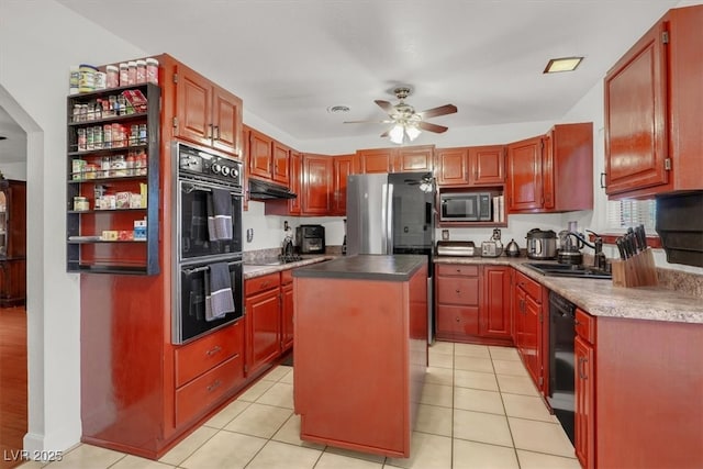 5005 Harmony Ave, Las Vegas, NV 89107 - kitchen featuring black appliances, a ceiling fan, under cabinet range hood, a kitchen island, and light tile patterned flooring