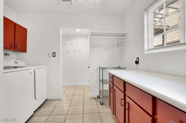 5005 Harmony Ave, Las Vegas, NV 89107 - washroom featuring cabinet space, washing machine and clothes dryer, and light tile patterned floors