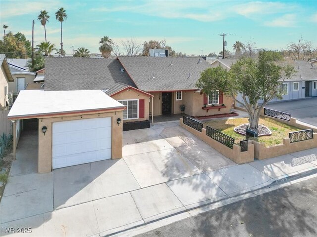 5005 Harmony Ave, Las Vegas, NV 89107 - view of front of property with a fenced front yard, a garage, driveway, and stucco siding