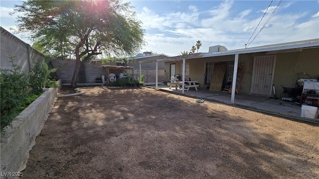 5209 Del Monte Ave, Las Vegas, NV 89146 - fenced backyard with a patio area