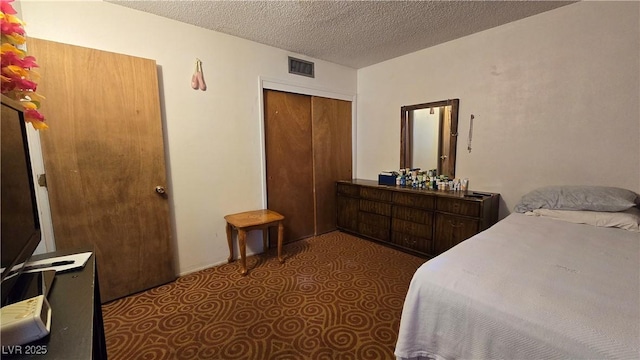 5209 Del Monte Ave, Las Vegas, NV 89146 - bedroom with tile patterned floors, a textured ceiling, and a closet