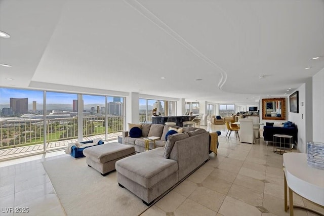 3111 Bel Air Dr Unit 21A & 21C, Las Vegas, NV 89109 - living area with a city view, healthy amount of natural light, light tile patterned floors, recessed lighting, and a wall of windows