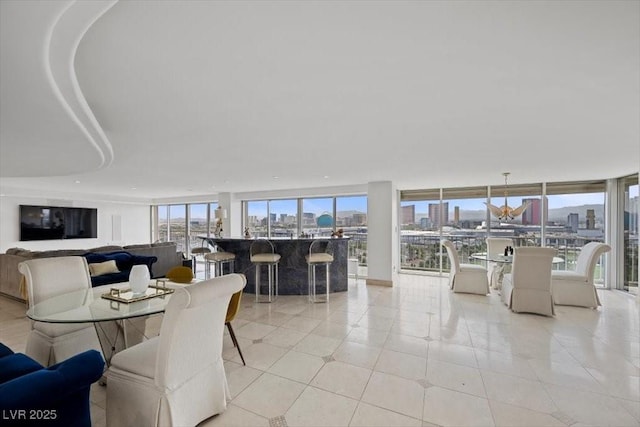 3111 Bel Air Dr Unit 21A & 21C, Las Vegas, NV 89109 - dining space with a view of skyline, light tile patterned floors, and a wall of windows